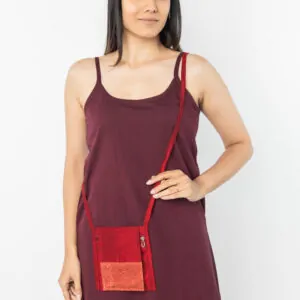 Maroon sling bag for women used during meditation, eco-friendly crossbody design with long strap