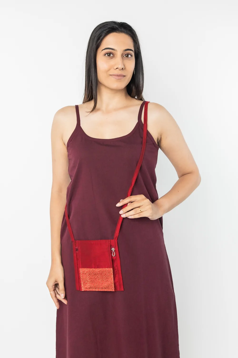 Maroon sling bag for women used during meditation, eco-friendly crossbody design with long strap